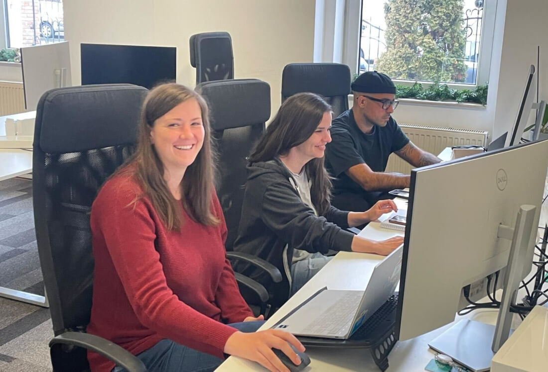 Three frontend team members working on their laptops during the work week.
