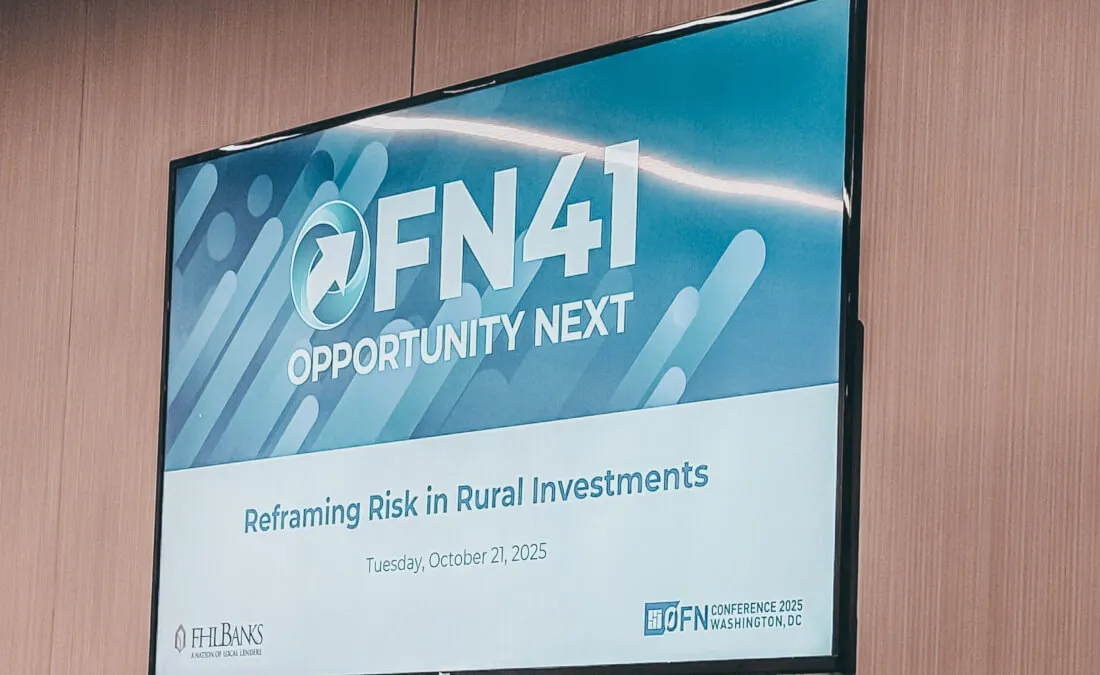 A television screen displaying a conference slide titled “OFN41 Opportunity Next – Reframing Risk in Rural Investments.”