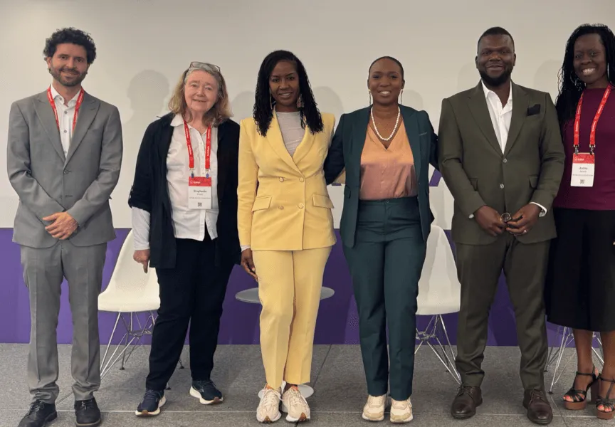 A group photo of participants who took part in a panel discussion convened by the Interledger Foundation at the 2025 Payments Canada Summit. The group stands together, smiling, in front of a summit-branded backdrop.