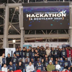 Group photo of all hackathon participants standing on stage at the UCT Financial Innovation Hub.
